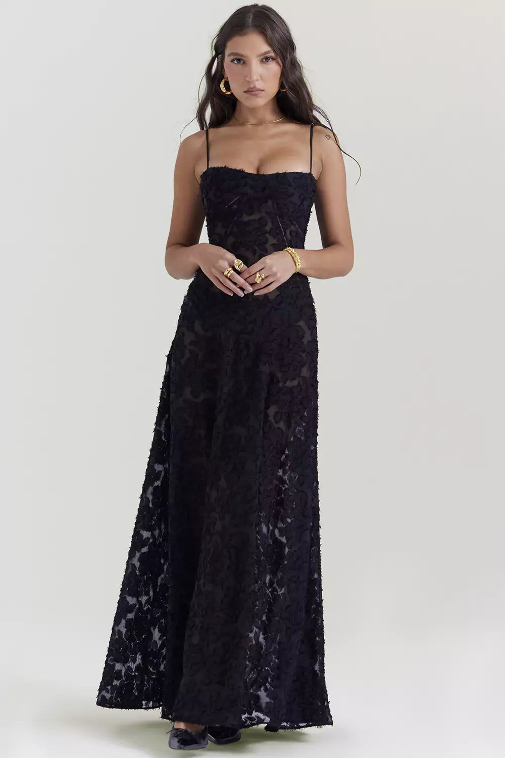 The model is wearing a black lace dress.