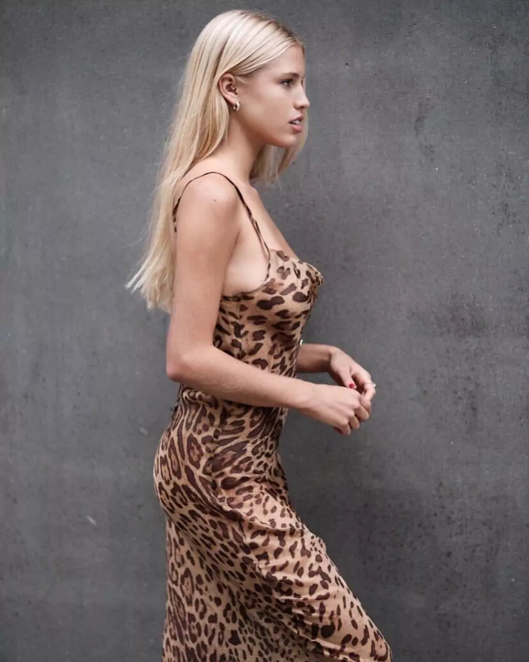 A blonde woman in a leopard print dress.