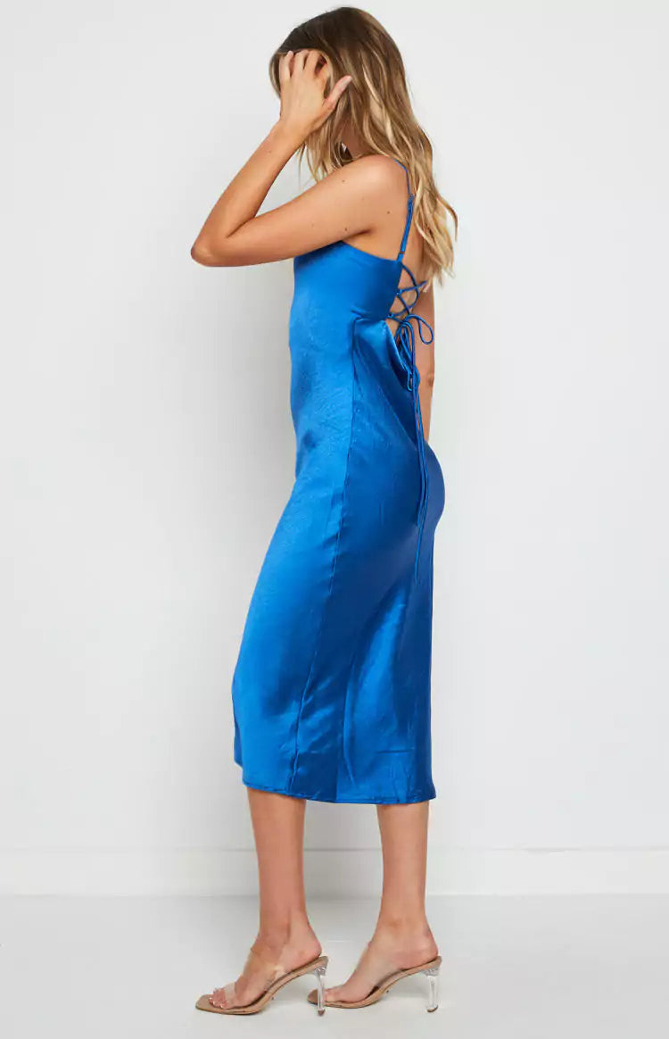 A woman wearing a blue satin slip dress, perfect for a night out.