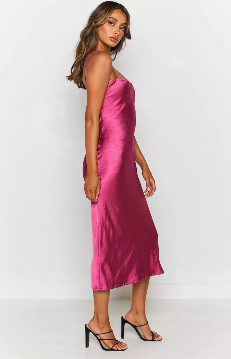 The model is wearing a pink satin slip dress.