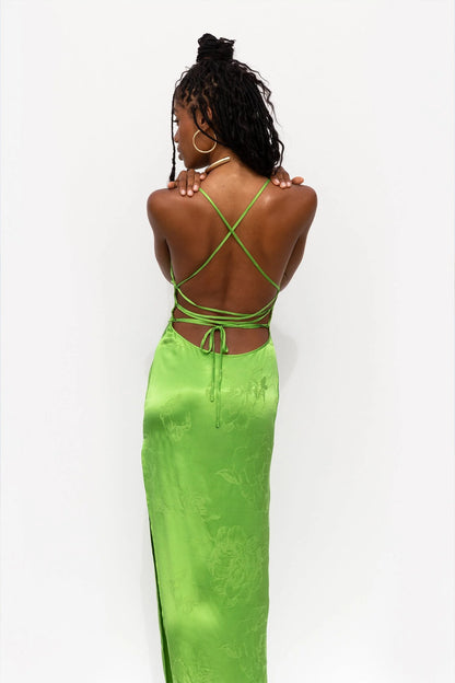 The back of a woman in a green floral slip dress boho collection available on cult crush