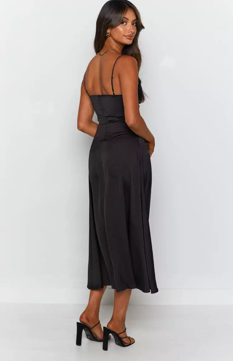 The back view of a woman wearing a black satin slip dress for a Matric Dance.