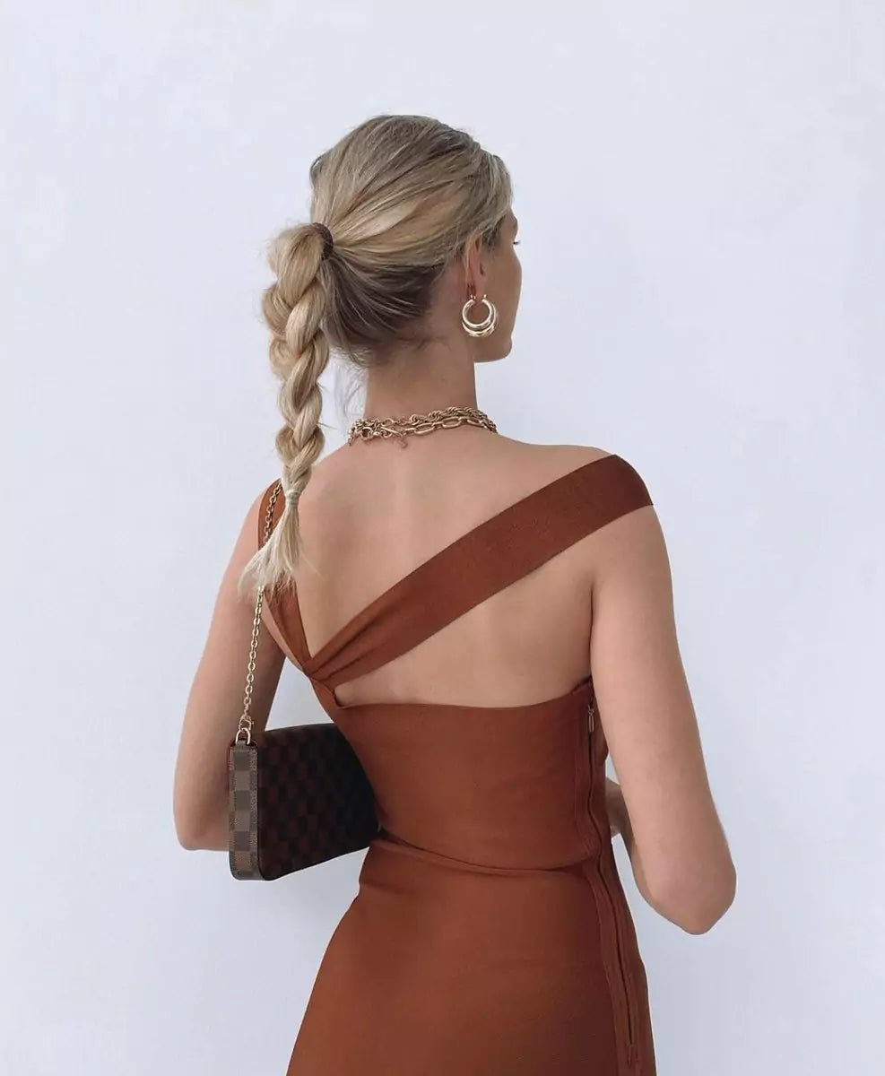 The back view of a woman wearing a brown dress.