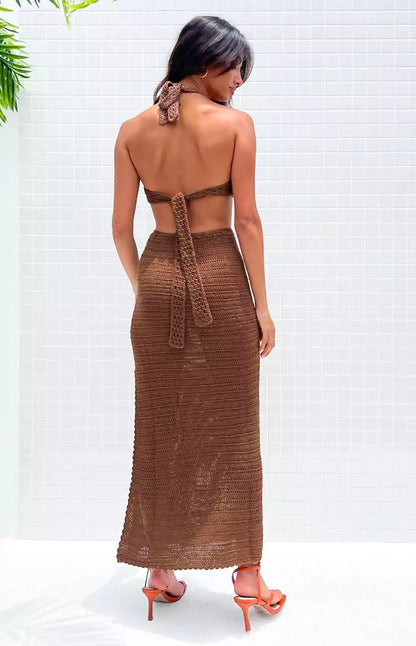 The back view of a woman wearing a brown maxi dress.
