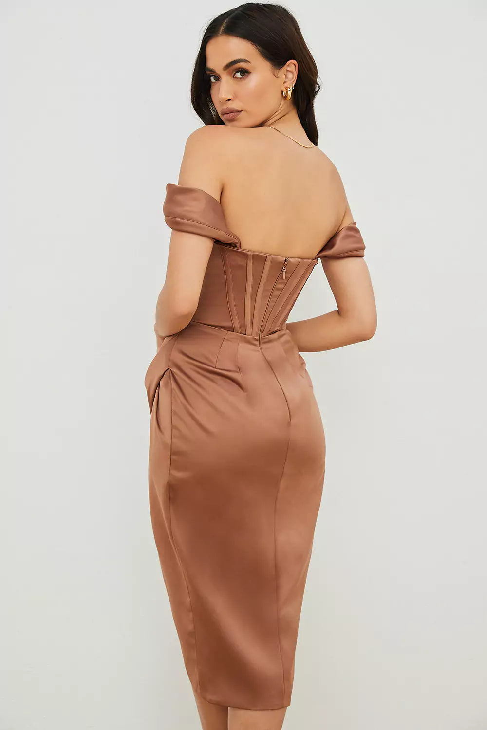 The back view of a woman in a brown satin midi dress.