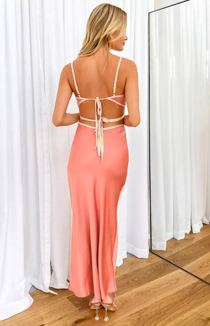 The back view of a woman in a peach maxi dress.