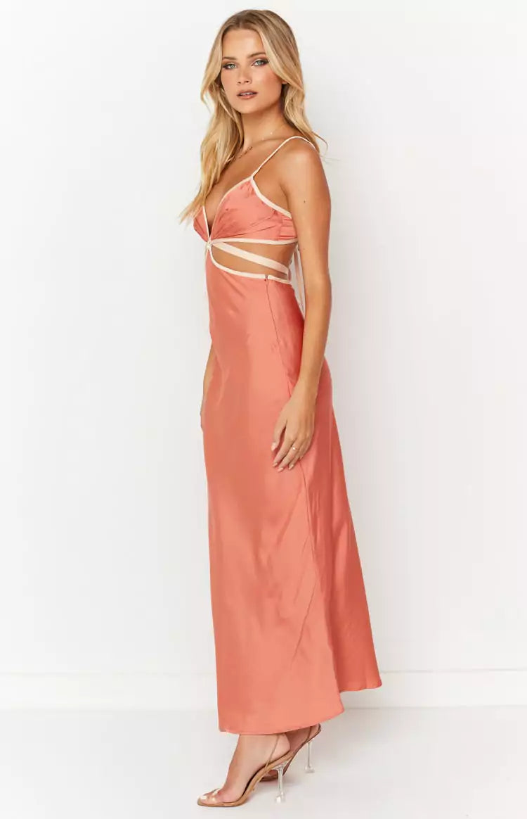 A model wearing a peach satin maxi dress.