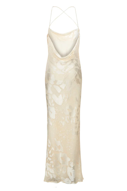 A white silk slip dress with a floral pattern.