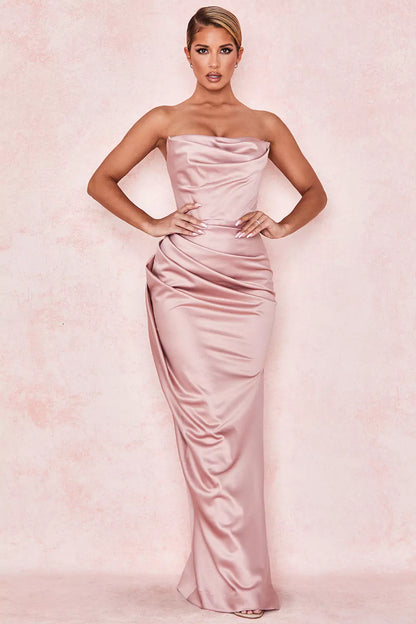 The model is wearing a pink strapless maxi dress.