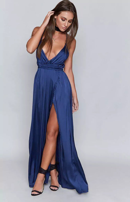 The model is wearing a blue maxi dress with a high slit.