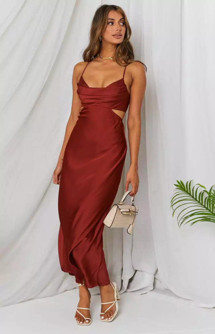 The model is wearing a burgundy satin midi dress.