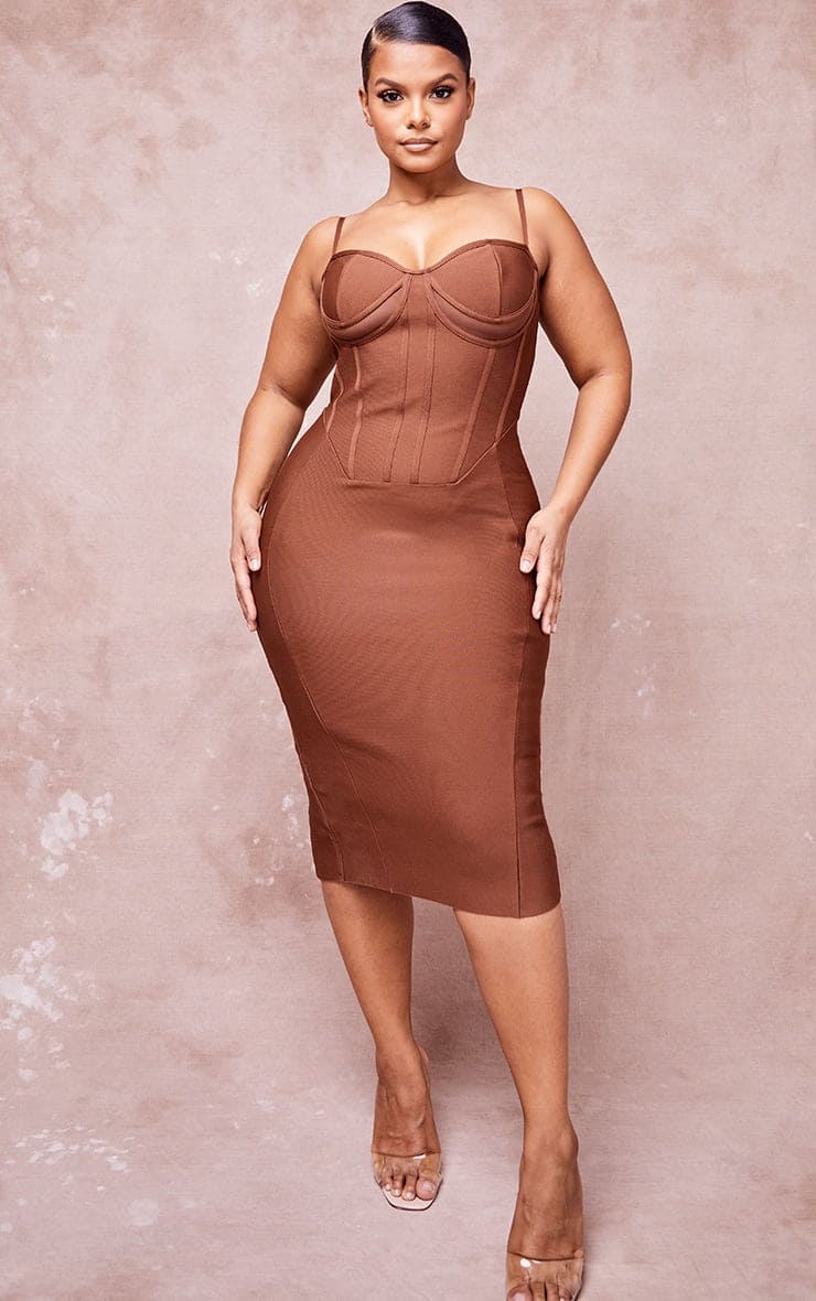 The model is wearing a Luciella chocolate bandage cut out midi dress.