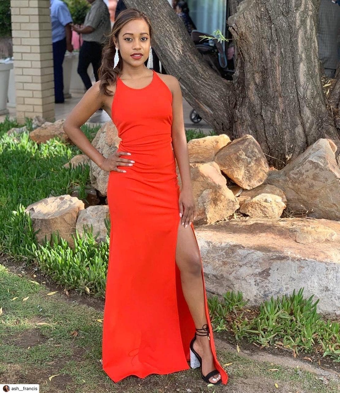 A woman in a red dress posing for a picture