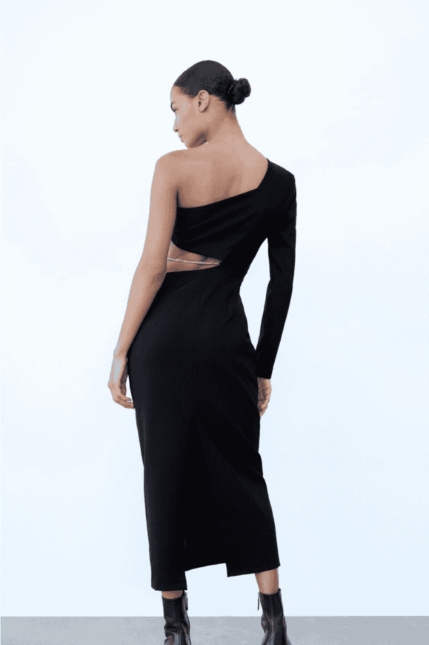 The back view of a woman wearing a black one shoulder dress.