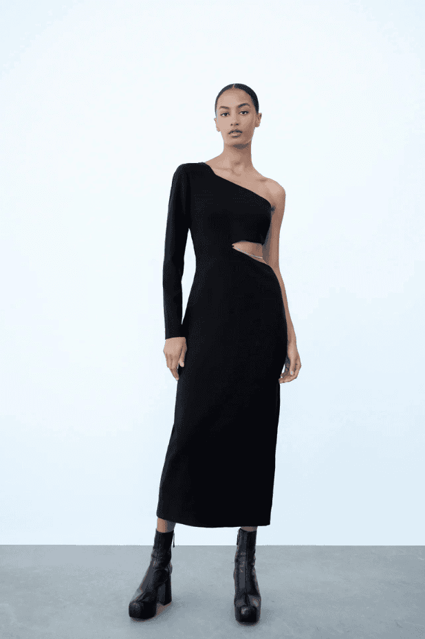 The model is wearing a limited edition black Zara Siena dress with one shoulder.