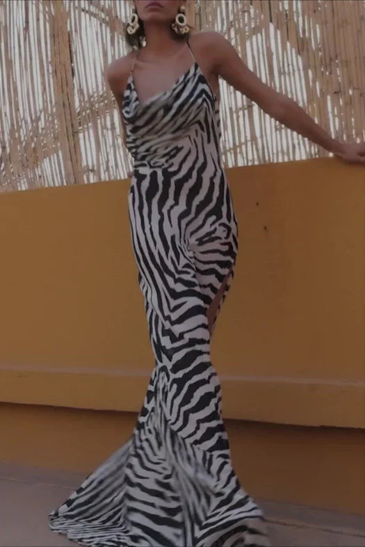 A woman is posing in a zebra print dress.