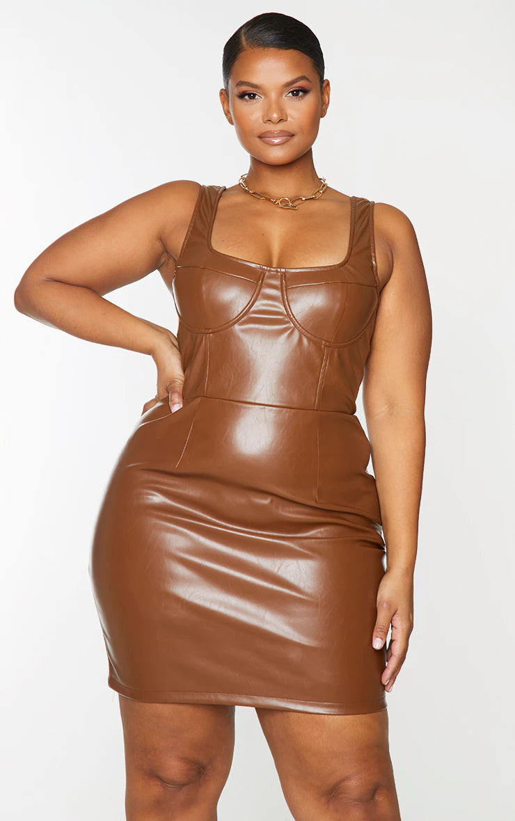 A woman wearing a brown leather mini dress.
