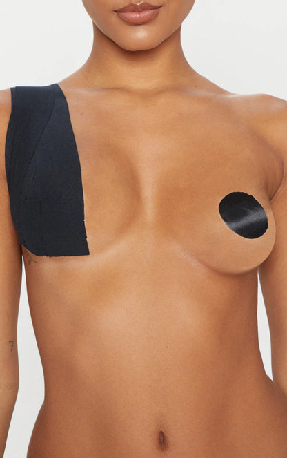 A woman with a black patch on her breast.