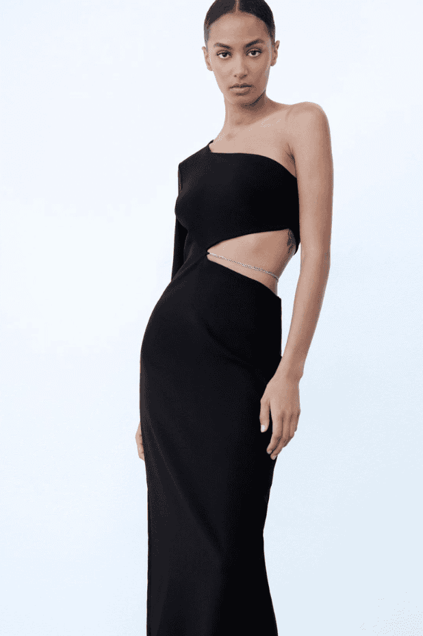 A model is wearing a black one shoulder gown.