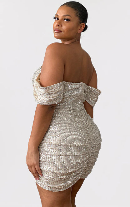 The back of a woman wearing a gold sequin dress.