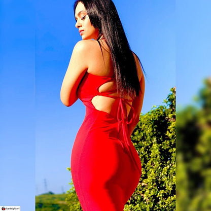 A woman in a red maxi dress with strappy back