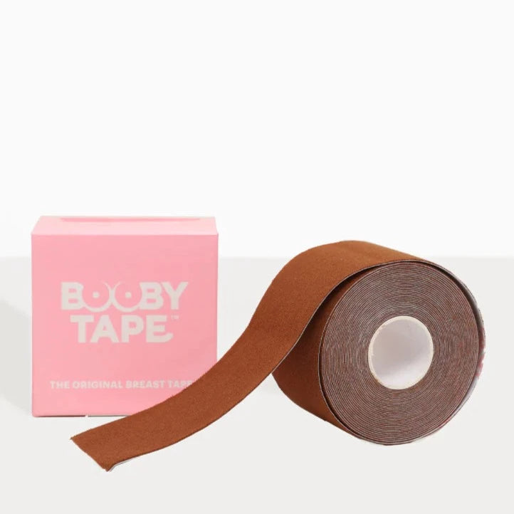 A roll of brown booby tape with a a pink box next to it.